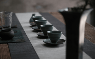 Tea ceremony setup with traditional ceramic tea cups arranged on a table, showcasing the cultural heritage and artistry of tea rituals.