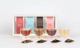 O2H TEA Flower Tea Set display, featuring the luxurious rooibos 'Cederberg Sunrise', classic 'O2H Breakfast', rich 'Pu-erh Earl Grey', and delicate 'Sakura Oolong' teas, presented with clear tea cups and assorted loose leaf teas for the ultimate tea enthusiast's gift set.