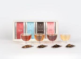 O2H TEA Flower Tea Set display, featuring the luxurious rooibos 'Cederberg Sunrise', classic 'O2H Breakfast', rich 'Pu-erh Earl Grey', and delicate 'Sakura Oolong' teas, presented with clear tea cups and assorted loose leaf teas for the ultimate tea enthusiast's gift set.