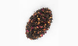 Loose blend of Hawthorn Pu-erh Tea displaying rich dark Pu-erh tea leaves, rose petals and bright hawthorn berries