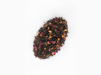 Loose blend of Hawthorn Pu-erh Tea displaying rich dark Pu-erh tea leaves, rose petals and bright hawthorn berries