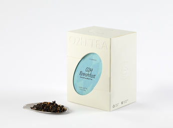 O2H Breakfast Tea box next to a sample of its Osmanthus Black Tea leaves, showcasing their rich colour and delicate osmanthus flowers.