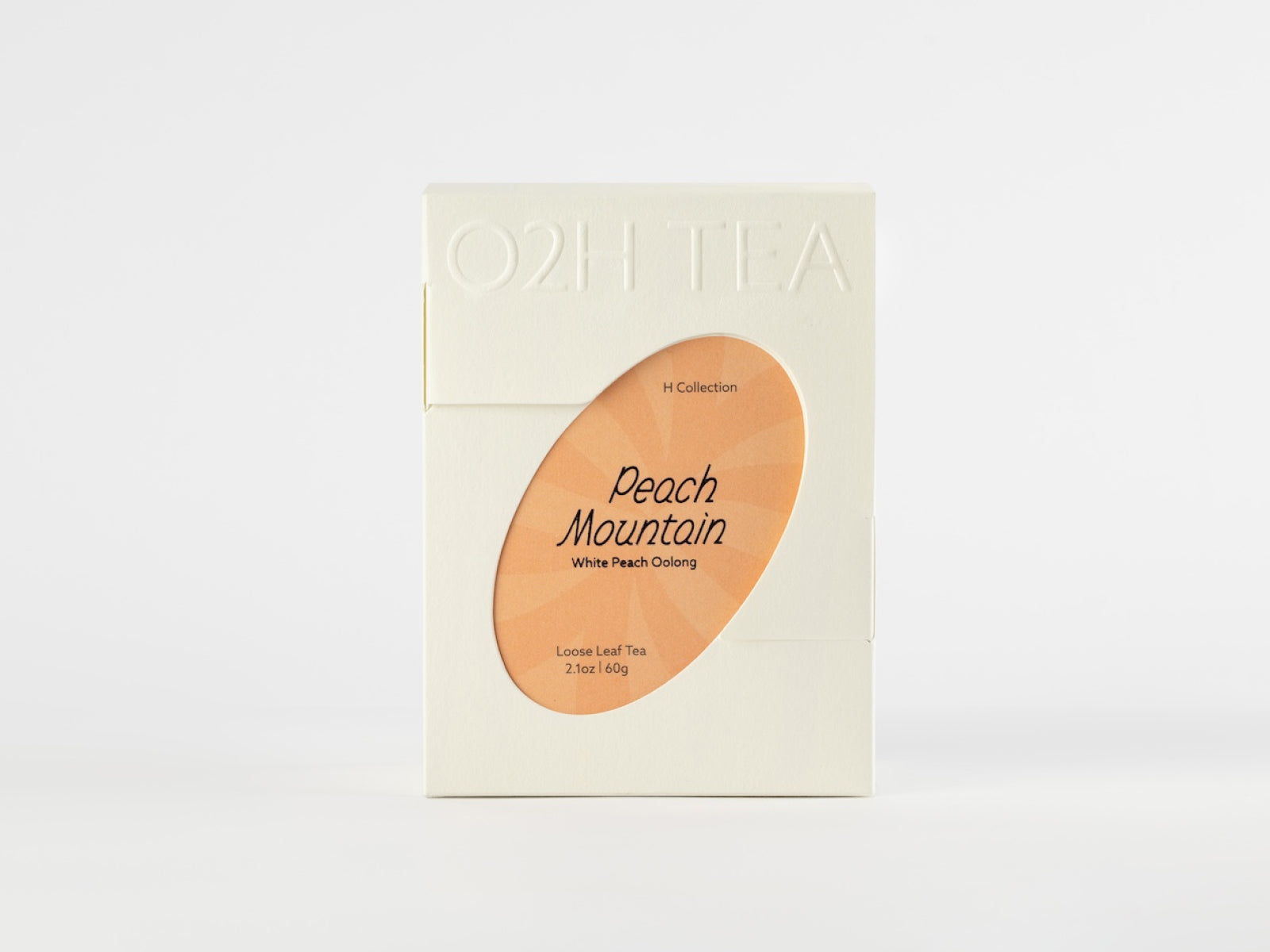 White Peach Oolong Tea in an elegant white package, featuring a transparent window showcasing the product name Peach Mountain