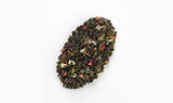 Detailed close-up of White Peach Oolong Tea blend, featuring delicate oolong leaves intertwined with dried peach slices.