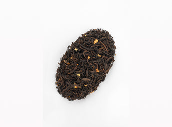 Loose blend of Pu-erh Grey Tea with visible hints of rose petals among the traditional Chinese pu-erh tea leaves