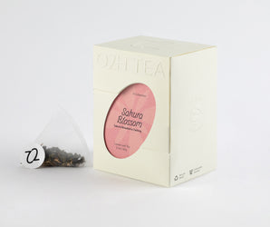 Pack of Sakura Strawberry Oolong Tea featuring a transparent tea bag with a blend of oolong, sakura blossoms, and strawberry pieces.