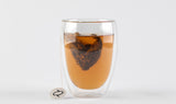 Aromatic infusion of Cederberg Sunrise tea served in a modern double-walled glass